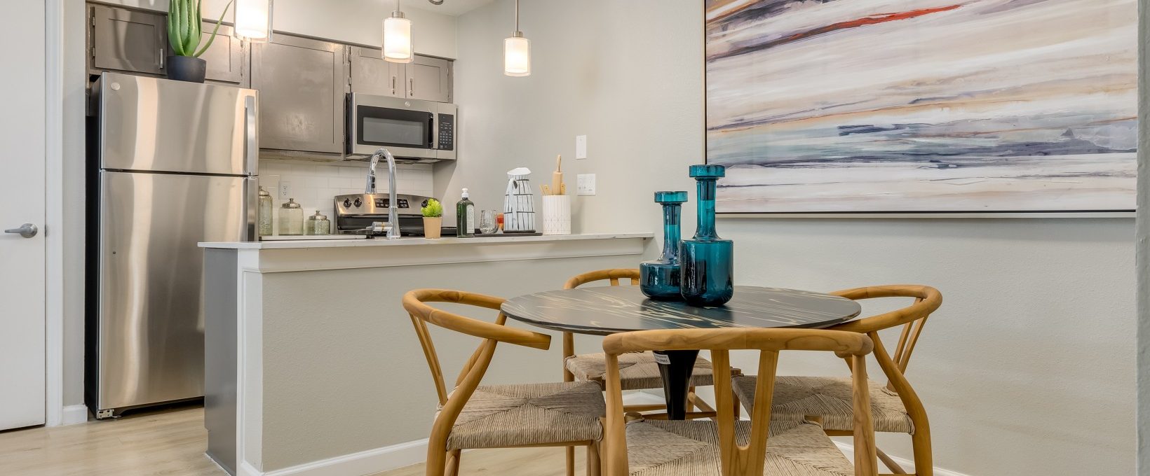 a kitchen and dining area with a large painting on the wall at The Winslow