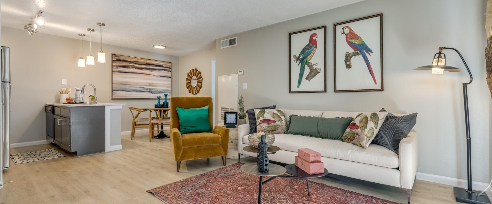 a living room with a couch, coffee table and a rug at The Winslow