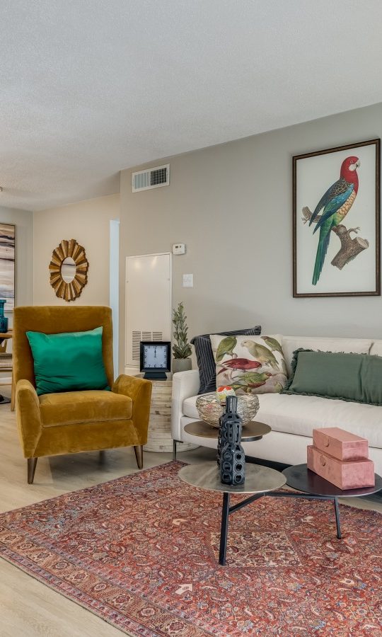 a living room with a couch, coffee table and a rug at The Winslow