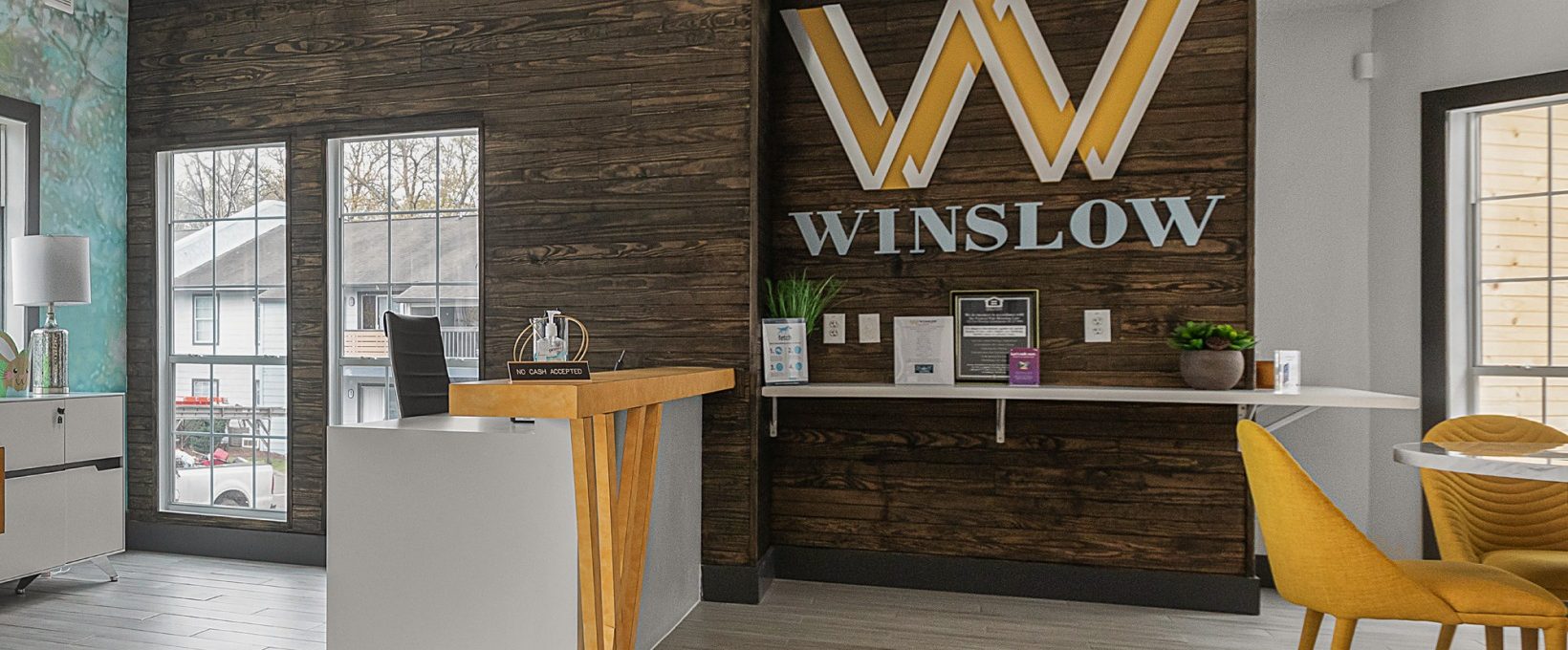 the front desk of a hotel with a sign that says winlow at The Winslow