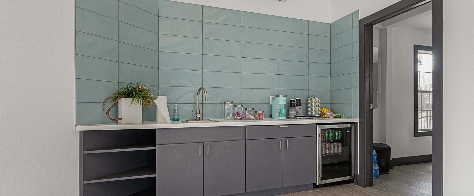 a kitchen with a sink and a refrigerator at The Winslow